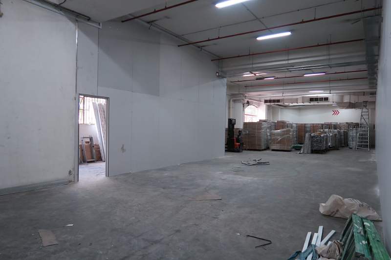 Before: bare unit interior with pallets of packed materials at the far end - Boltless Racking - B7 | Wong Lye Racking, Singapore Racking Manufacturer
