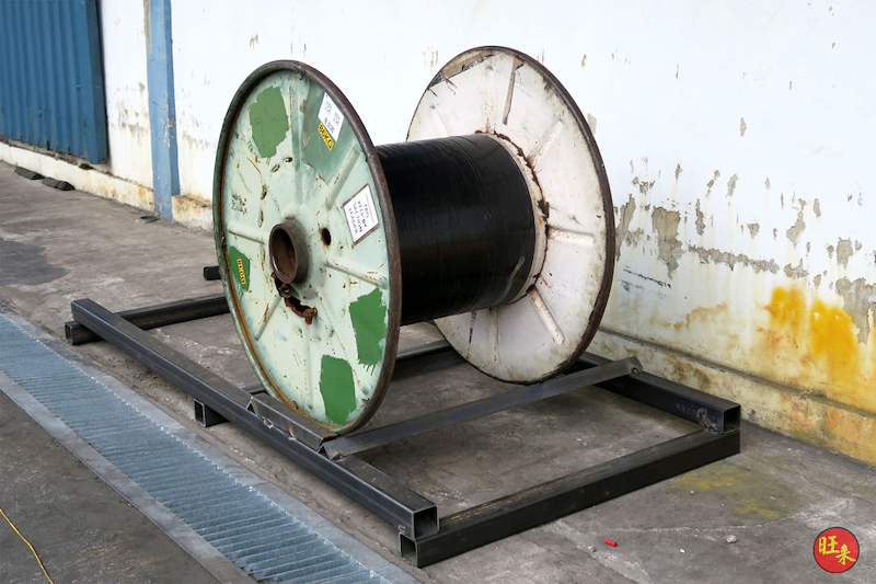 Cable drum test-fitted on the steel base frame beside the drain channel - V5000 Racking - V5-1 | Wong Lye Racking, Singapore Racking Manufacturer