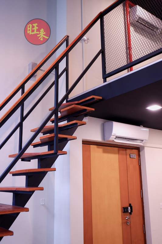 Open-tread staircase rising past the loft railing with a doorway below - V5000 Racking - V5-26 | Wong Lye Racking, Singapore Racking Manufacturer