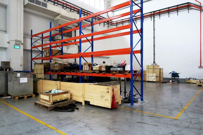 V3000 racking run against the wall with timber crates and pallets on the floor in front - V3000 Racking - V3-5 | Wong Lye Racking, Singapore Racking Manufacturer