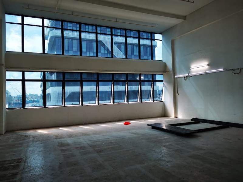 Tall window wall of the unit with mezzanine deck panels laid out on the floor - V5000 Racking - V5-9 | Wong Lye Racking, Singapore Racking Manufacturer