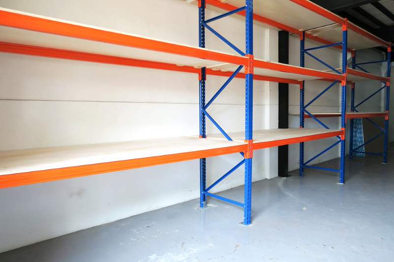 Empty V3000 racking bays with plywood decking on three orange beam levels - V3000 Racking - V3-2 | Wong Lye Racking, Singapore Racking Manufacturer