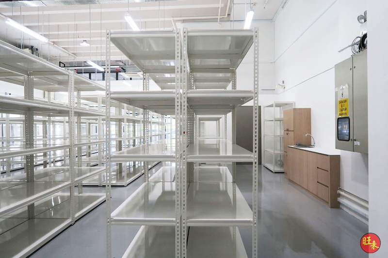 After: white boltless shelving rows beside the pantry counter and electrical panel - Boltless Racking - B8 | Wong Lye Racking, Singapore Racking Manufacturer