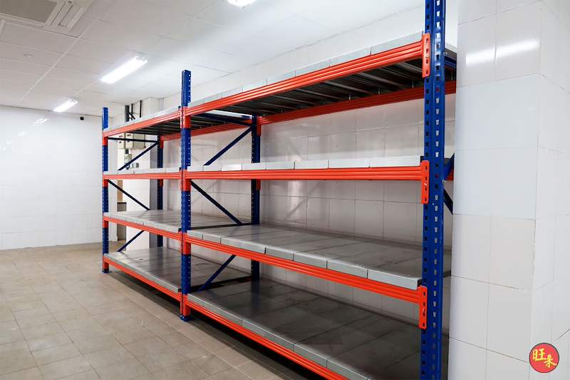 End of the long-span racking run showing the blue upright frame with bracing and orange beams - Boltless Racking - B5 | Wong Lye Racking, Singapore Racking Manufacturer