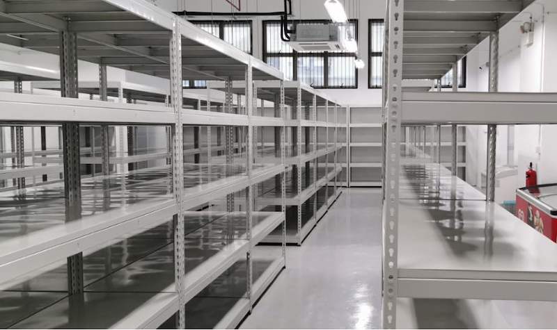 Aisle between rows of grey boltless shelving with steel shelf panels - Boltless Racking - B1 | Wong Lye Racking, Singapore Racking Manufacturer
