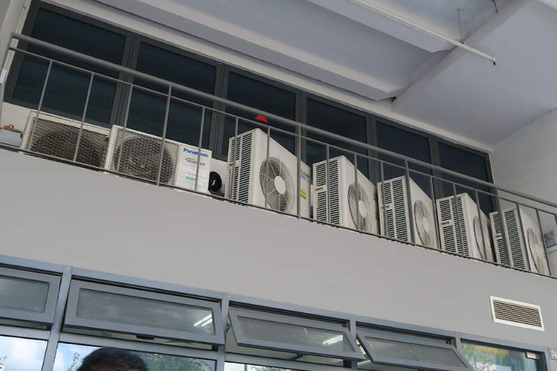 Air-conditioning condensers on the ledge above the window wall, viewed from below - Boltless Racking - B8 | Wong Lye Racking, Singapore Racking Manufacturer